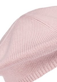 Soft pink knitted wool beret with ribbed texture and subtle seam detail.