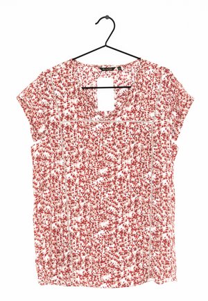Kurzärmelige Bluse mit rotem und pinkfarbenem Blumenmuster, V-Ausschnitt und dekorativer weißer Naht, an einem schwarzen Kleiderbügel hängend.