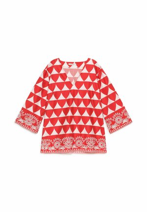 Blusa a maniche lunghe rossa e bianca con motivo geometrico a triangoli e bordi floreali su polsini e orlo, con scollo a V.