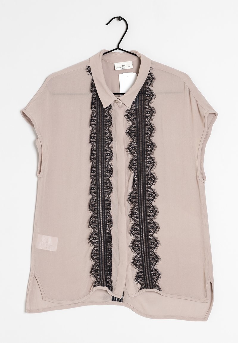 Light beige short-sleeve blouse with a lace panel down the center featuring black floral patterns and a button-up collar.