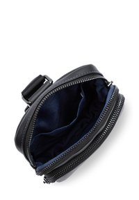 Borsa rotonda in pelle nera con chiusura a zip e rivestimento in tessuto blu. Presenta una tasca con zip e un attacco per tracolla regolabile.