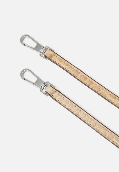 Two beige faux leather straps feature a textured pattern and silver-toned metal clips for attachment, designed for bags or accessories.