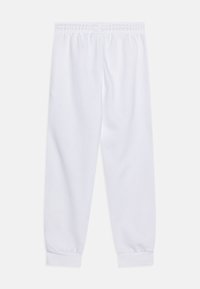 Hvite joggebukser laget av mykt stoff, med elastisk midje og mansjetter. Glatt tekstur uten synlige mønstre eller logoer.