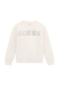 Krémová mikina so zaobleným výstrihom a dlhými rukávmi. Má výrazné strieborné logo "GUESS" na prednej strane. Mäkká textúra látky.
