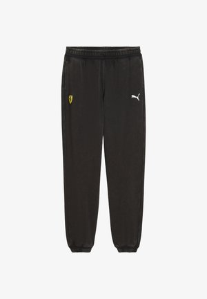 Černé tepláky s elastickým pasem. Na levé straně se nachází malé žluté logo Ferrari a na pravé straně bílé logo Puma.