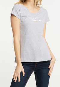 Gray cotton T-shirt with a round neckline and short sleeves, featuring the word "Moin" in white and yellow lettering across the front.