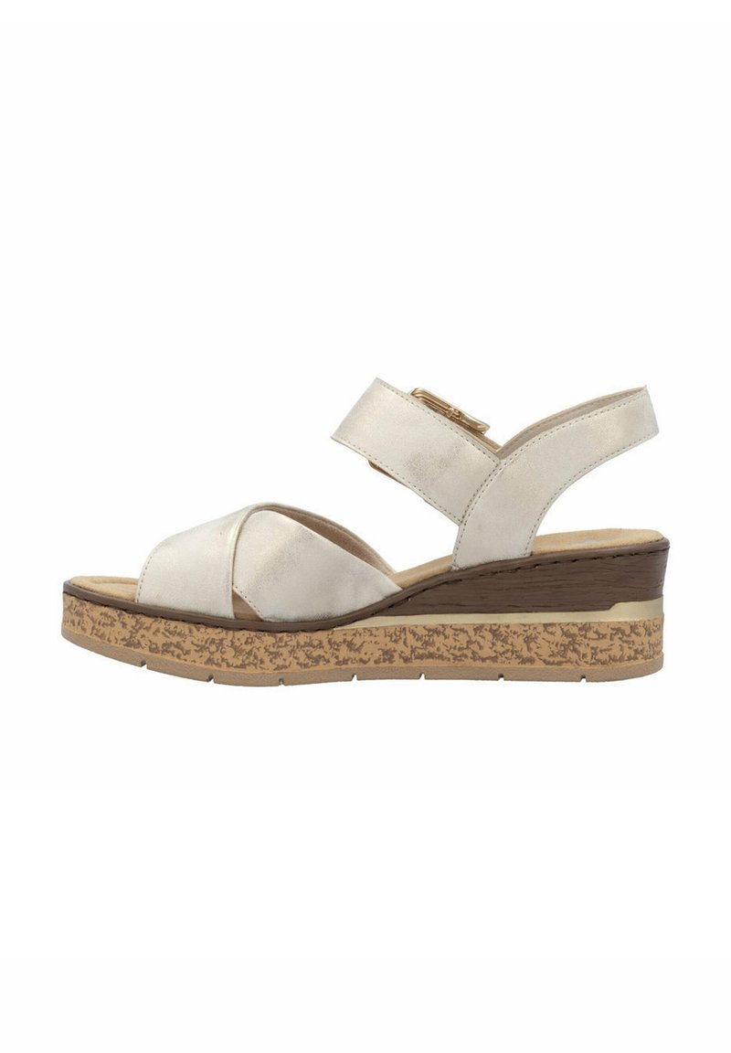 Wedge sandal with a light beige synthetic upper, crossed straps, adjustable buckle, and a textured cork sole. Flat heel accent.