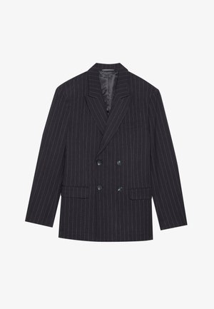 Juodas švarkas su smulkiomis juostelėmis, dvigubai užsegamas, su įstrižais atlapais, dviem priekinėmis kišenėmis ir šešiais mygtukais; glotnus paviršius ir pritaikytas siluetas.