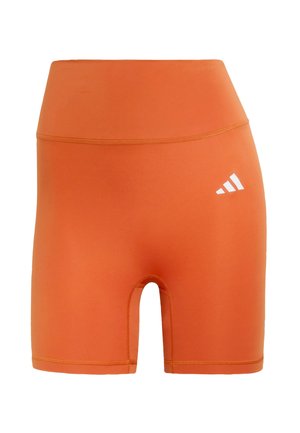 Orange athletic shorts made of stretchy material. High-waisted design with a cut-out leg and a small white logo on the side.
