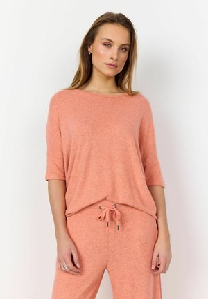 Lightweight, loose-fitting, short-sleeve top in soft peach with a round neckline and a subtle texture, paired with matching drawstring pants.