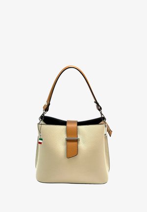 Leather handbag in cream with a smooth texture, brown accent strap, and silver hardware detail. Features a top closure and attached tag.