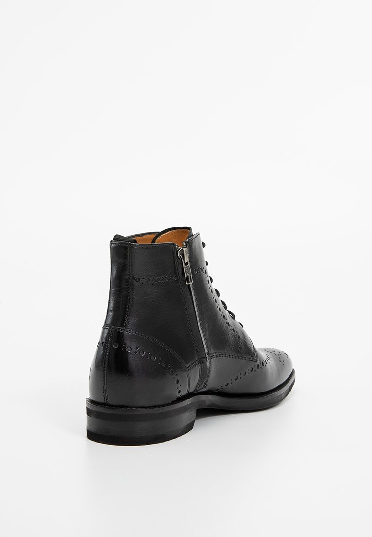 Schwarze Leder-Ankle-Boots mit Broguedetails, runder Zehenform, Schnürung vorne, seitlichem Reißverschluss und glatter Oberfläche. Höhe: Wadenlang.