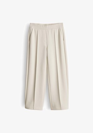Beige weit geschnittene Hose mit elastischem Bund und Seitentaschen, vorne mit Falten und einem lockeren, lässigen Sitz.