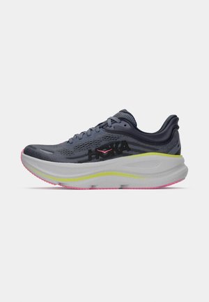 Chaussure de course Hoka gris foncé avec logo noir, semelle épaisse gris clair avec une bande jaune et semelle extérieure rose, présentée en profil latéral.