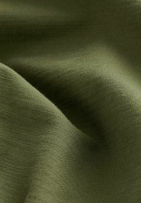 Dark olive green fabric with a soft texture, featuring a subtle weave pattern and gentle draping. No visible hardware or accents.