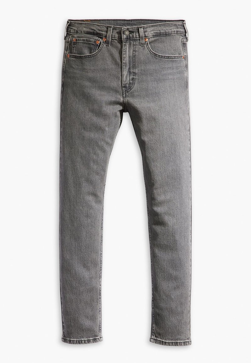 Jeans de mezclilla gris con corte slim, que cuentan con bolsillos frontales, un bolsillo para monedas y costuras en contraste. La tela tiene una textura ligeramente desgastada.