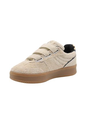 Baskets en textile beige avec fermeture velcro, semelle en caoutchouc gomme, surface texturée et subtil accent noir le long du bord.