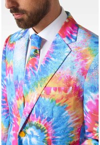 Brightly colored suit featuring a tie-dye pattern in blue, pink, yellow, and green. Smooth fabric with a single chest pocket and yellow buttons.