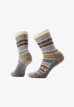 Knit socks featuring a multi-pattern design in gray, cream, and tan with yellow and black accents, ribbed cuffs, and reinforced heel and toe.