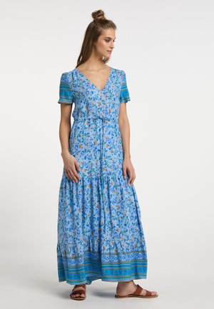 Maxime dress made of light blue fabric with floral print. Features short sleeves, a V-neck, and a tiered hem with a decorative border at the bottom.