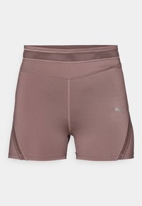 Shorts de sport mauves taille haute avec panneaux en mesh, coutures plates et un petit logo Puma sur la cuisse droite.