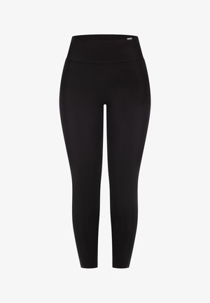 Leggings noirs en matériau extensible avec une taille haute et une texture lisse et mate, présentant un branding subtil près de la taille.