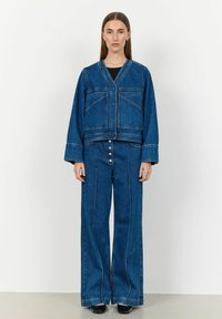 Modra denim jakna s V-izrezom, dvojni sprednji žepi in široke hlače, ki usklajene, z kontrastnim šivanjem in gumbnim zapenjanjem.