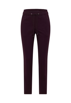 Fioletowe spodnie dresowe z miękkiego materiału, z elastycznym paskiem w talii, zwężanymi nogawkami i delikatnym połyskiem. Brak widocznych kieszeni lub wzorów.