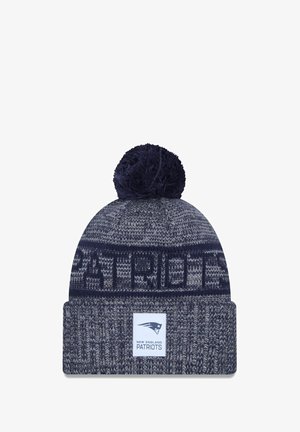 Navy blue knit beanie with a pom-pom and cuff, featuring grey patterns and a logo patch that reads "NEW ENGLAND PATRIOTS."