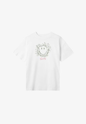 White cotton t-shirt featuring a green floral wreath design around a smiling face, with "Smiley" text in pink below the graphic.