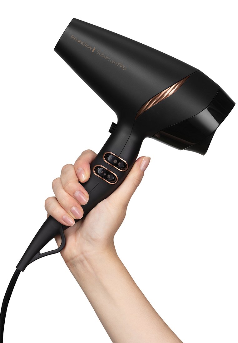 Suszarka do włosów Remington Supercare Pro z matowym czarnym korpusem i różowo-złotymi akcentami, elegancka konstrukcja oraz dwa przyciski sterujące na uchwycie.