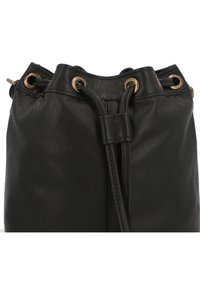 Black leather bag featuring a drawstring closure with gold-tone eyelets, softly textured surface, and a round shape.