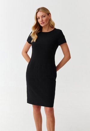 Black short-sleeve dress with a fitted silhouette, smooth texture, knee-length, and subtle horizontal stripe detail. Simple round neckline.