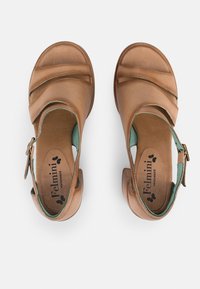 Brown leather shoes with an open toe, featuring curved straps and mint green accents. Heel height is moderate, with a buckle closure.