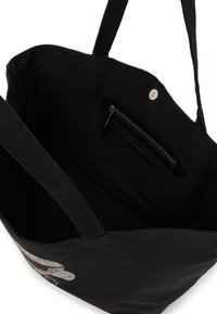 Black canvas tote bag with two shoulder straps, featuring a zippered pocket inside and an embroidered design on the exterior.