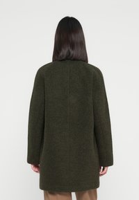 Olive green wool coat with a straight cut, long sleeves, and a clean, seamless back design, featuring a subtle texture.
