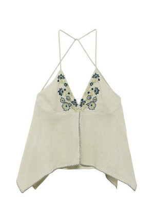 Light beige linen top with a V-neck and decorative blue floral embroidery. Features thin straps and a flowing, asymmetric cut with exposed stitching.