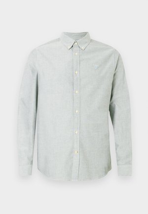 Camisa de botão de manga longa cinza-claro com colarinho com botões e pequeno logótipo bordado no lado esquerdo do peito.