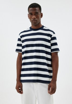 Camiseta a rayas azul marino y blanca, de mangas cortas, cuello redondo, de material de algodón, con un ajuste relajado, con un patrón de rayas horizontales y costuras visibles.
