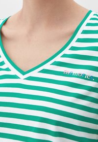 Zeleno-bílý pruhovaný tričko s výstřihem do V, vyrobené z měkkého materiálu, s vyšitým nápisem "vzpomínky" v vícebarevných písmech na hrudi.