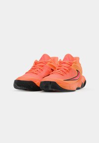 Bright orange athletic shoes with textured mesh upper, black rubber sole, and contrasting black and pink accents on the sides and laces.