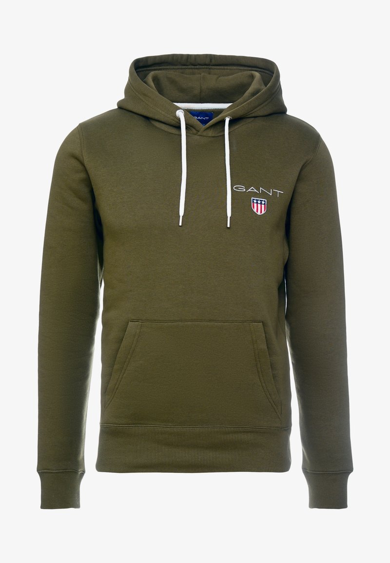 Sweat à capuche vert olive avec cordons blancs, poche avant et logo GANT avec écusson rouge, blanc et bleu sur la poitrine.
