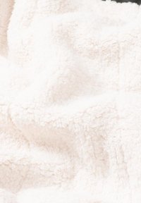 Soft, plush white fabric with a fluffy texture, displaying a wrinkled pattern and a thick, cozy appearance.