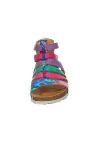 Colorful sandal with multiple straps in pink, purple, and green; floral pattern on blue base; cork sole; open toe and heel design.