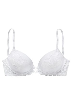 White bra featuring padded cups, lace detailing with swirl patterns, adjustable straps, and a decorative front closure with circular accents.