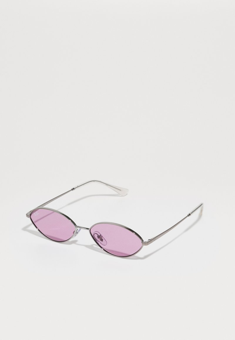 Metal frame sunglasses with elongated oval pink lenses. Arms are slender and silver-toned, showcasing minimalistic design.