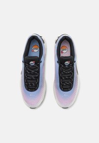 Nike Air Max sneakers feature a gradient mesh upper in hues of blue and pink, black laces, and a white sole. Air Max branding visible on the tongue.