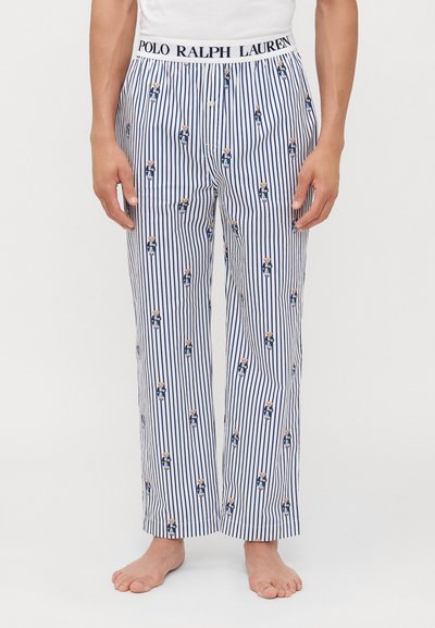 Baumwollschlafanzughosen mit schmalen blauen und weißen Streifen, die ein sich wiederholendes Muster eines Bären im Anzug zeigen. Elastischer Bund mit Logo.