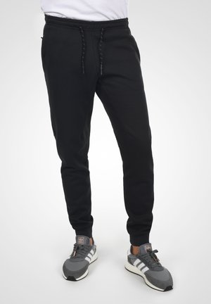 IDNAPANEE - Tracksuit bottoms - black