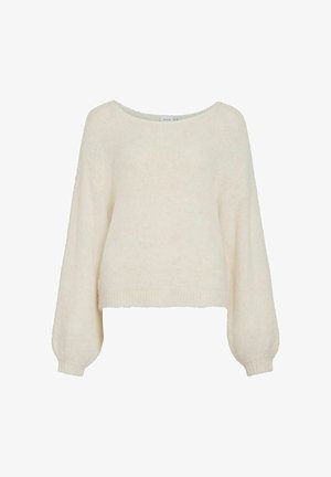 Jersey de color crema, corto, con un ajuste holgado, mangas largas y anchas, y una textura suave y peluda. Presenta un escote amplio y redondeado.